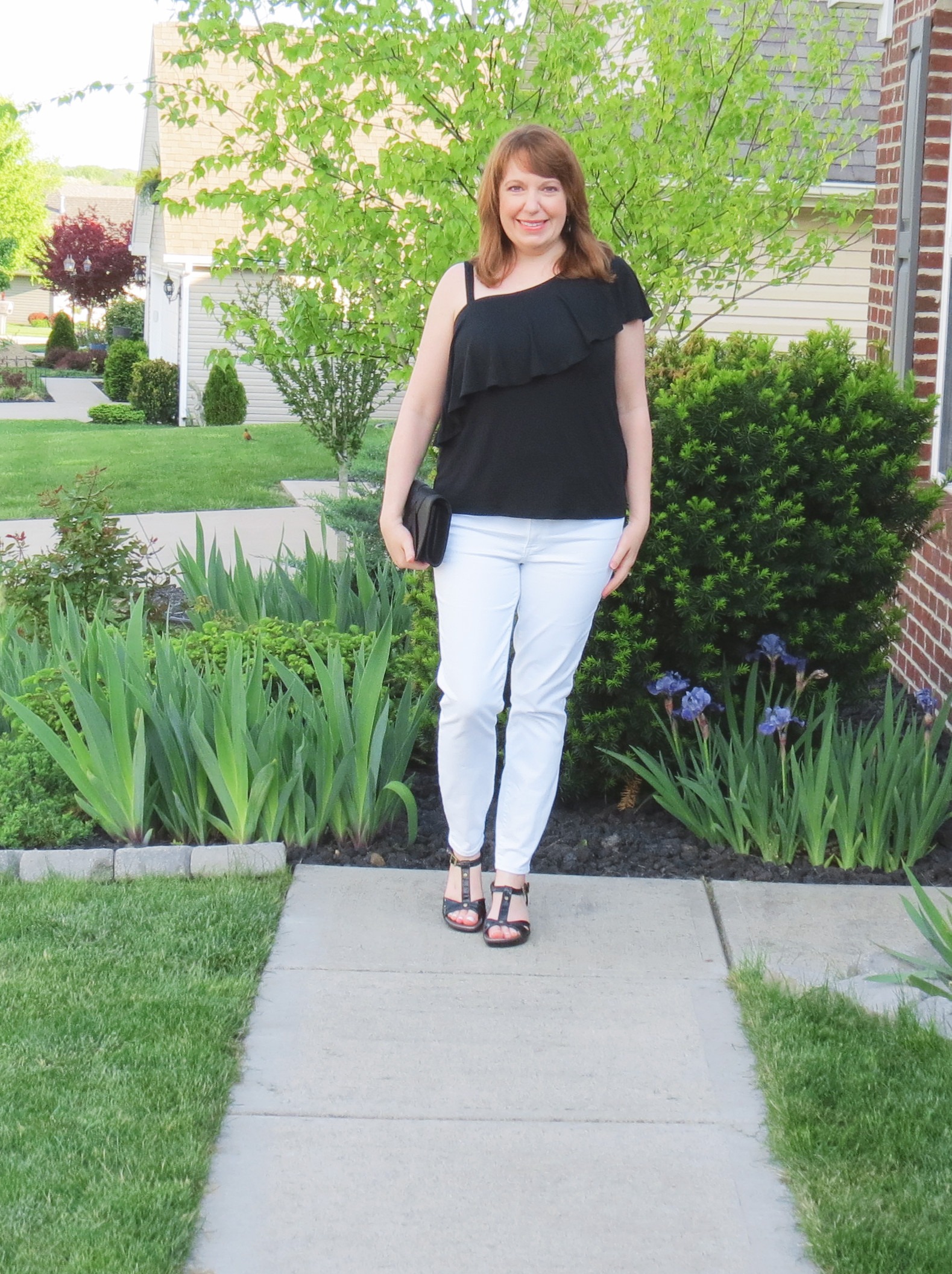 Black One Shoulder Top With White Jeans And Black Clutch