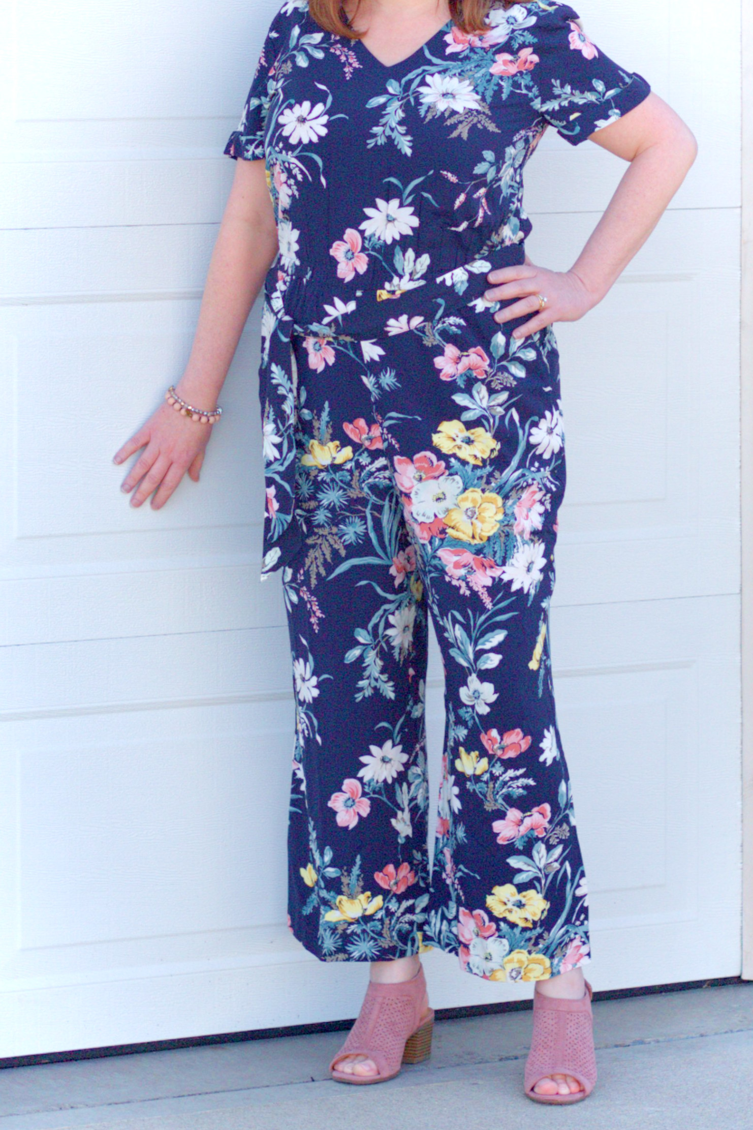 Closeup Of A Floral Jumpsuit With A Navy Background