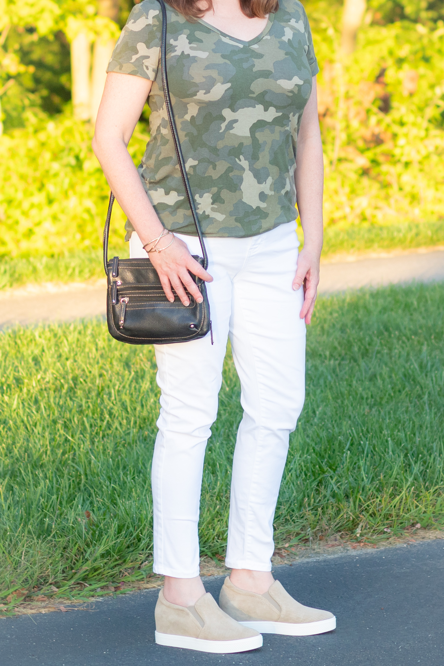 Closeup of Camo Tee, White Jeans, Handbag, & Sneakers