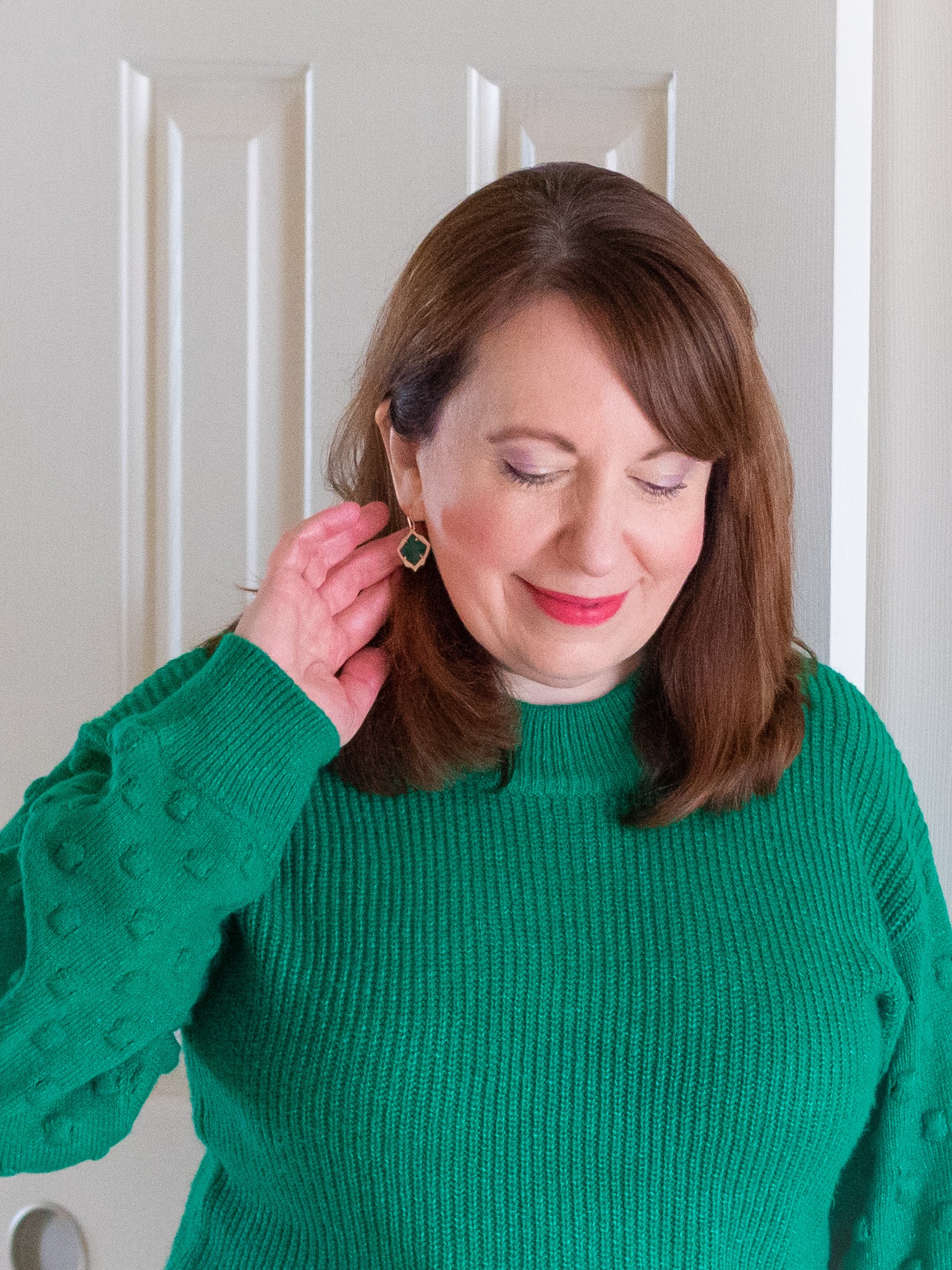 Dianna Wearing Clairol Root Touchup Powder on Brows, a Green Sweater, & Earrings